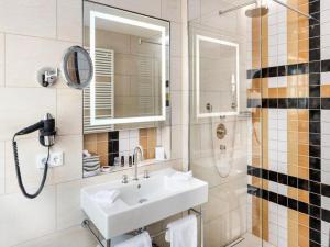 圣彼得奥尔丁AALERNHÜS Residences in St Peter-Ording的浴室配有洗手池、镜子和淋浴。