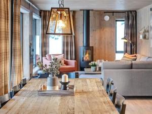 a living room with a table and a couch at 10 person holiday home in Fåvang in Favang