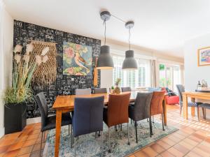 a dining room with a table and chairs at Cozy villa with wellness tub, sauna and garden in Den Ham