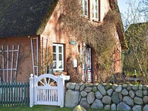 a house with a white fence in front of it at Ferienwohnung in Oevenum auf Foehr in Oevenum +34 photos