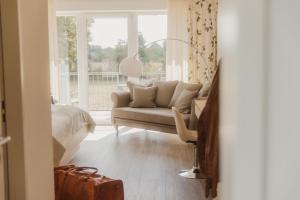 a living room with a couch and a window at Landhotel Stähle in Schüttorf