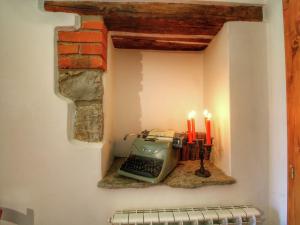 a room with a typewriter in a wall with candles at Rustic Holiday Home in Ortignano with Swimming Pool in Castel Focognano