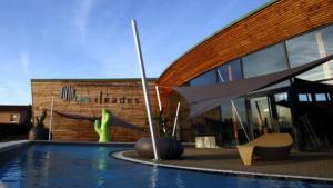 a building with a swimming pool in front of a building at HOTEL RESTAURANT CIRIUS in Montrond-les-Bains