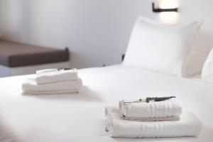 圣彼得罗斯Spanos Apartments - Andros的酒店客房的床上配有2条毛巾