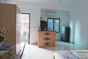 a kitchen with a counter and a refrigerator in a room at Biển Xanh 303DM in Hanoi