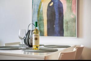 a bottle of wine sitting on top of a table at CASA FABi in Arrieta +9 photos