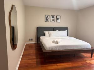a bedroom with a bed with a teddy bear on it at Exquisite 3 KINGs bed 5 mins EWR airport 25 mins from NYC in Newark