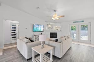 a living room with two couches and a table at Tranquil Haven - Pet Friendly in Perdido Key