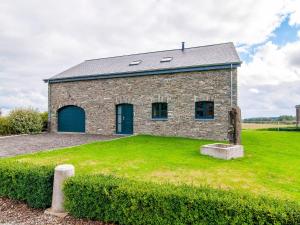 a brick building with blue doors on a grass field at Nature Escape in Nafraiture in Nafraiture