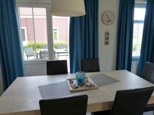 a dining room table with a plate of food on it at Rural holiday home with terrace in Breskens +58 photos