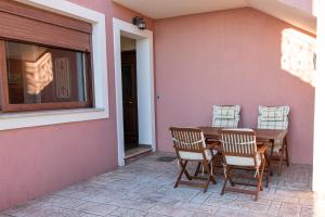 a wooden table and chairs on a patio at Naiad Sea View Studio in Poros