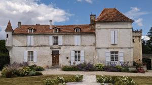 a large stone house with a red roof at Montboulard in Soyaux
