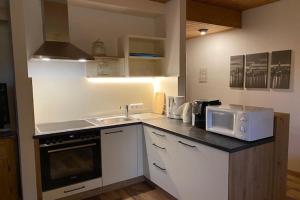 a kitchen with a sink and a microwave at Wohnung in Tauplitz nahe Skilift in Tauplitz