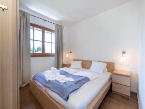 ein Schlafzimmer mit einem Bett mit weißen Laken und einem Fenster in der Unterkunft Apartment in Mittersill near Ski Bus & Slopes in Hollersbach im Pinzgau