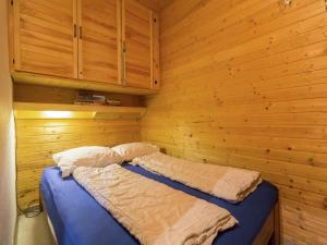 a bedroom with a bed in a wooden wall at Apartment in Tauplitz near Ski Lift in Tauplitz +33 photos