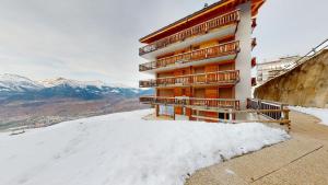 a building on top of a snow covered mountain at Plein Ciel VA 010 - MOUNTAIN apartment 8 pers in Veysonnaz
