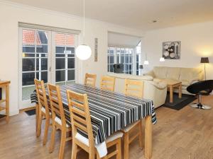 a dining room and living room with a table and chairs at 6 person holiday home in Skagen-By Traum in Skagen