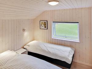 a bedroom with two beds and a window at 5 star holiday home in Kappeln in Kappeln +16 photos