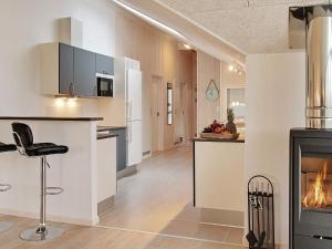 a kitchen and living room with a fireplace at 5 star holiday home in Kappeln in Kappeln