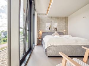 a bedroom with a bed and a large window at Ferienhaus in Fuhlendorf in Fuhlendorf