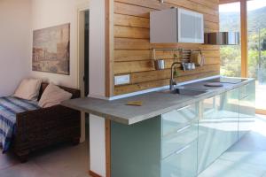 a kitchen with a counter with a sink in it at Holiday home Biocasa Fabiana, Portoferraio Magazzini in SantʼAnna