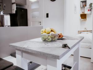 a bowl of fruit on a table in a kitchen at Comfortable apartment close to the sea, Pobierowo in Pobierowo