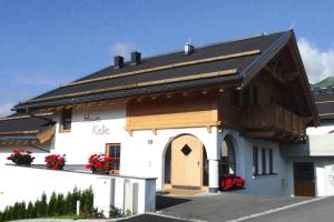 a white building with a wooden door and a balcony at holiday home, Fiss in Fiss