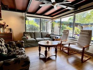 a living room with a couch and chairs and a table at Holiday home for 6 in Sint Maartenszee in Sint Maartenszee