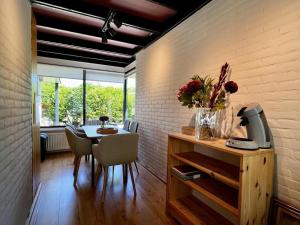 a dining room with a table and chairs and a wall at Holiday home for 6 in Sint Maartenszee in Sint Maartenszee