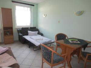 a living room with a couch and a table with chairs at Pension Barghus GmbH in Zinnowitz