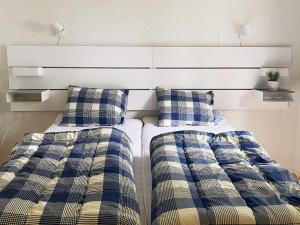 two beds sitting next to each other in a bedroom at 4 star holiday home in Gislaved in Gislaved +23 photos