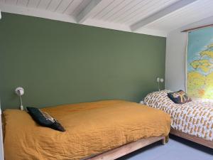 a bedroom with two beds and a map on the wall at Holiday Home in Dishoek near Southern Beach in Dishoek