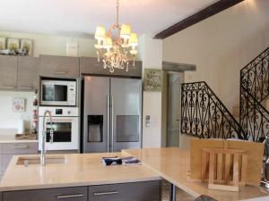 Una cocina con una mesa y una lámpara de araña. en Mas in Eygalières with Heated Pool, en Eygalières
