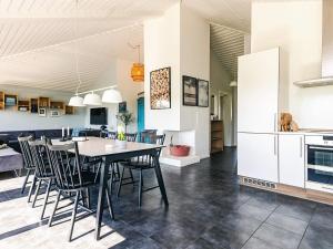 a kitchen and dining room with a table and chairs at Karrebæksminde Fjord Houses in Karrebæksminde