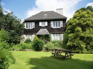 a house with a picnic table in front of it at Mansion in Spa Liege with private garden in Spa