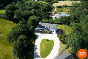 an overhead view of a house with a large green apple on the driveway at Heartbeat Cottage in Letterkenny