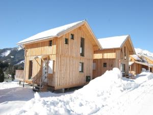 a wooden cabin in the snow with snow around it at Chalet in Hohentauern near Ski Lift in Hohentauern