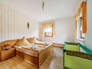 a bedroom with a bed and a table in it at Forest Retreat in Jägersgrün in Bad Reiboldsgrün