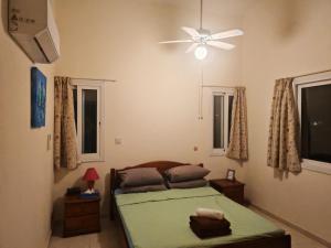 a bedroom with a bed and a ceiling fan at Poolside Escape - Polis in Polis Chrysochous +13 photos