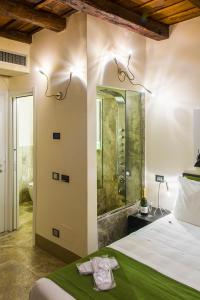 a bathroom with a shower and a bed in a room at Residenze Argileto in Rome +51 photos
