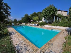 a swimming pool in the backyard of a house at Raffinée Farmhouse with pool views in Umbertide