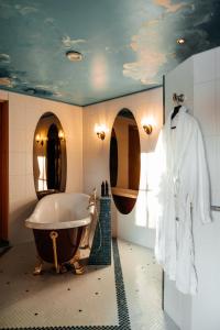 a bathroom with a bath tub and a sink at Kakslauttanen Arctic Resort - Igloos and Chalets in Saariselka +148 photos