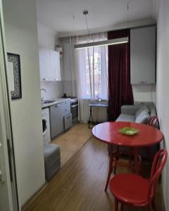 a small living room with a table and a kitchen at Cozy home office in Vake in Tbilisi City