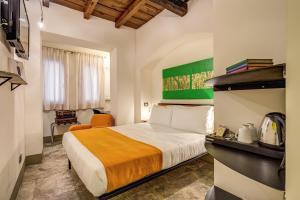 a hotel room with a bed and a chair at Casa Argileto in Rome