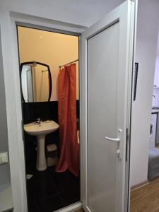 a bathroom with a sink and a mirror at Cozy home office in Vake in Tbilisi City +81 photos