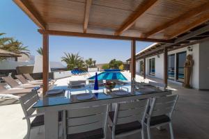 a dining table on the patio of a villa at Princesa Calero in Puerto Calero