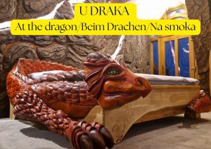 a wooden bed with a horse head on it at Hotel Kocourkov in Hlinsko