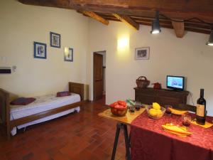 a room with a bed and a table with food on it at Raffinée Farmhouse with pool views in Umbertide