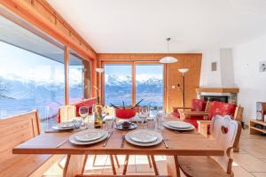 comedor con mesa y vistas a las montañas en Plein Ciel VA 013 - MOUNTAIN apartment 8 pers, en Veysonnaz
