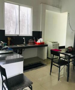 a kitchen with a sink and a table and chairs at Amith Home Stay Hikkaduwa in Hikkaduwa +15 photos